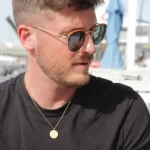 male model wearing Otis Redding Sittin On The Dock of the Bay lyric pendant modern lifestyle soul inspired look